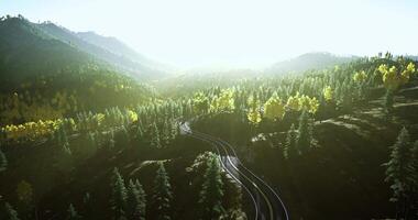 CGI Scenic view of winding train tracks through lush mountains during golden hour video