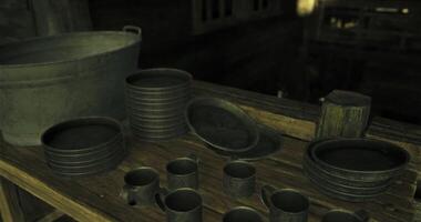 CGI Collection of rustic metal dishes and utensils displayed on a wooden table video