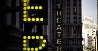 CGI Brightly illuminated theater signs at twilight in a bustling urban setting video