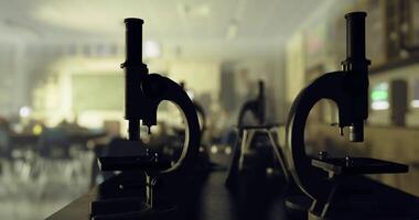 CGI Microscopes in a classroom setting during a science lesson in afternoon light video