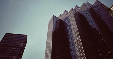 CGI Modern skyscrapers reflect the sky in a city setting during the day video