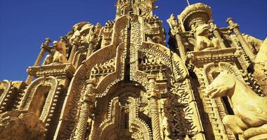 CGI Ornate stone structure adorned with intricate carvings under clear blue sky video