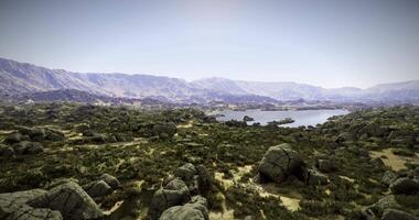 CGI Desert landscape with rocky hills and serene lake beneath clear skies video