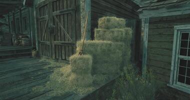 CGI Stacks of hay near a rustic wooden building in twilight video
