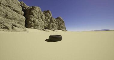 CGI Desert landscape with a lone tire resting on the sand in a rocky area video