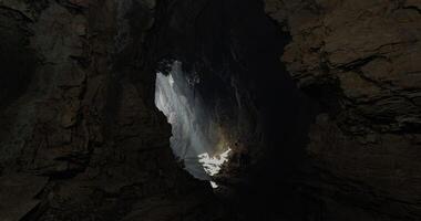 CGI Light breaks through the rocks in a stunning cave formation video
