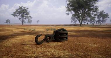 CGI Old mining hook rests on the dry ground in a remote landscape video