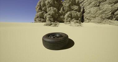 CGI Abandoned tire rests alone in sandy desert landscape under clear blue sky video
