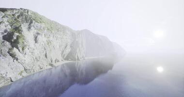 CGI Misty coastline at dawn, with cliffs and calm waters in serenity video