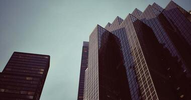 CGI Tall modern buildings reflect the sky in an urban environment video