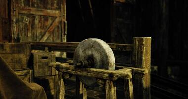 CGI Wooden structure with a stone wheel in a rustic workshop environment video
