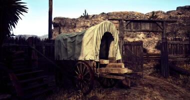 CGI Wagon parked at a rustic entrance in a desert landscape during daytime video