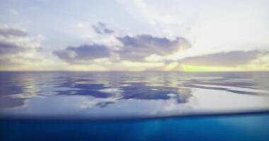CGI Calm ocean water reflects clouds and sunset colors in serene beauty video