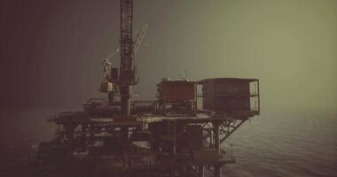 CGI Oil rig stands tall against the horizon in a hazy atmosphere video