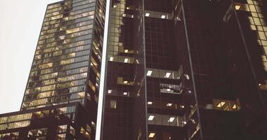 CGI High rise buildings illuminated during evening in urban landscape video