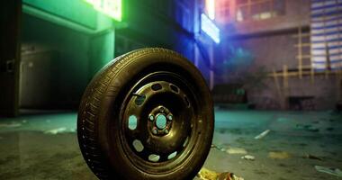 CGI Discarded tire rests on wet pavement in urban alley at night video