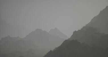CGI Misty mountain landscape at dawn with layered peaks and soft light video