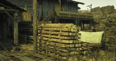 CGI Historic wooden structure and stacks of lumber near a wagon in a desert town video