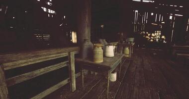 CGI Rustic barn interior with wooden tables and vintage containers in natural light video