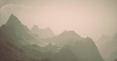 CGI Majestic mountain range under a soft hazy sky during sunrise video