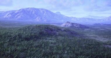 CGI Expansive landscape with mountains and grassy terrain under a blue sky video