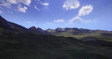 CGI Breathtaking mountain landscape under clear blue sky with fluffy clouds video