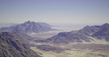 CGI Vast desert landscape showcasing rugged mountains and clear sky video