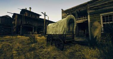 CGI Old wooden wagon near rustic buildings in a dusty setting at sunset video