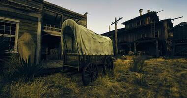 CGI Old western wagon near abandoned buildings in desert at sunset video