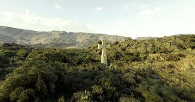 CGI Historical stone cross stands amidst rugged terrain in natural setting video