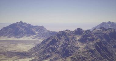 CGI Majestic mountain range with clear skies and distant horizon at midday video