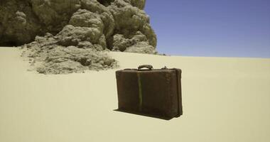 CGI Vintage suitcase resting on sandy terrain near rocky formations in desert video