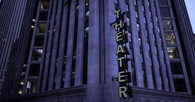 CGI Historic theater illuminated at night in a bustling city center video