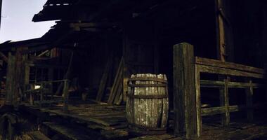 CGI Old wooden building with worn porch and rustic barrel in sunset light video