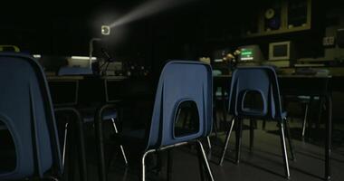 CGI Classroom in shadows with two desks and computer setup at night video