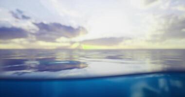 CGI Calm ocean waters reflect the colorful sky at sunset near the horizon video