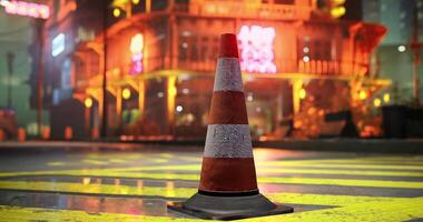 CGI Traffic cone stands on crosswalk in vibrant urban setting at night video
