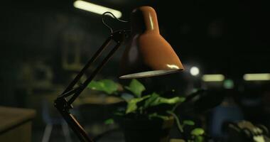 CGI Workspace relaxation with a desk lamp and a potted plant in a dimly lit room video