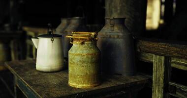 CGI Vintage milk cans on rustic wooden table in a dimly lit barn video