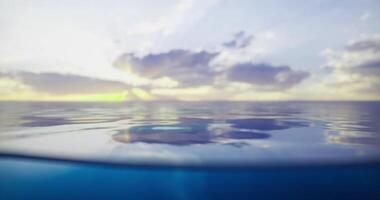 CGI Beautiful sunset over calm ocean water with reflections and clouds video