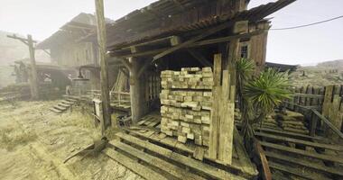 CGI Old wooden structure with stacked lumber in a deserted outdoor setting video