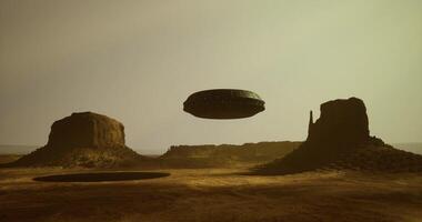 CGI Mysterious UFO hovering over desert landscape at sunset video