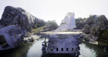 CGI Aircraft wreckage nestled among rocky terrain near a serene body of water video