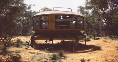 CGI Unique futuristic structure in arid landscape surrounded by trees video