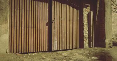 CGI Wooden gate against a textured stone wall in a rustic setting video