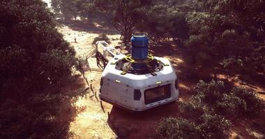 CGI Futuristic habitat nestled among trees in a remote landscape during daytime video
