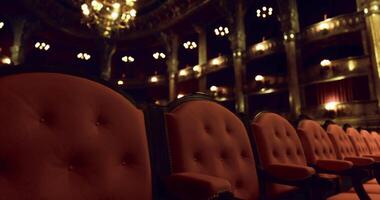 CGI Elegant red seats arranged in a vintage theater setting at night video