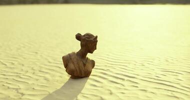 CGI Sculpture of a classical bust in a sunlit sandy landscape during golden hour video