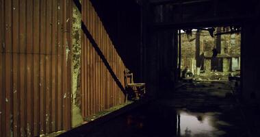 CGI Abandoned building with a solitary chair and dim light streaming through video