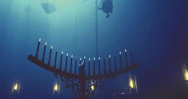 CGI Mysterious lighting in an ancient hall with a grand menorah overhead video